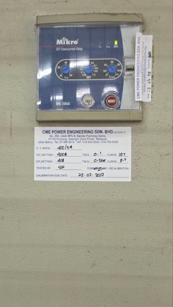 Close-up of an electrical protection relay and calibration label