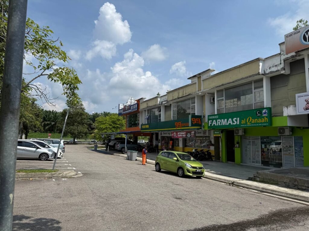 Exterior view of the commercial row with 99 Speed Mart and other neighbouring shops visible.
