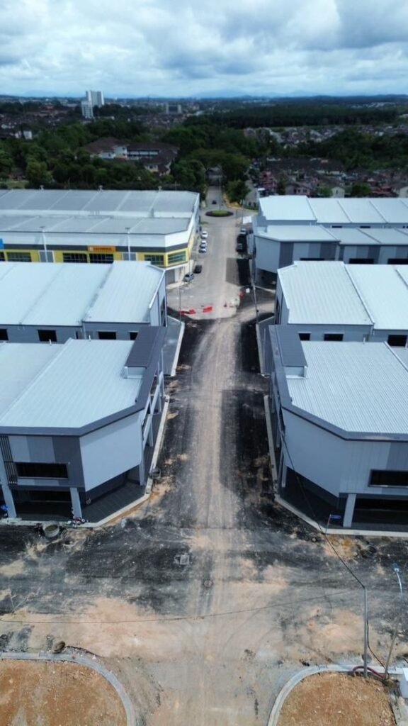 Drone view of factory and warehouse buildings along a central road