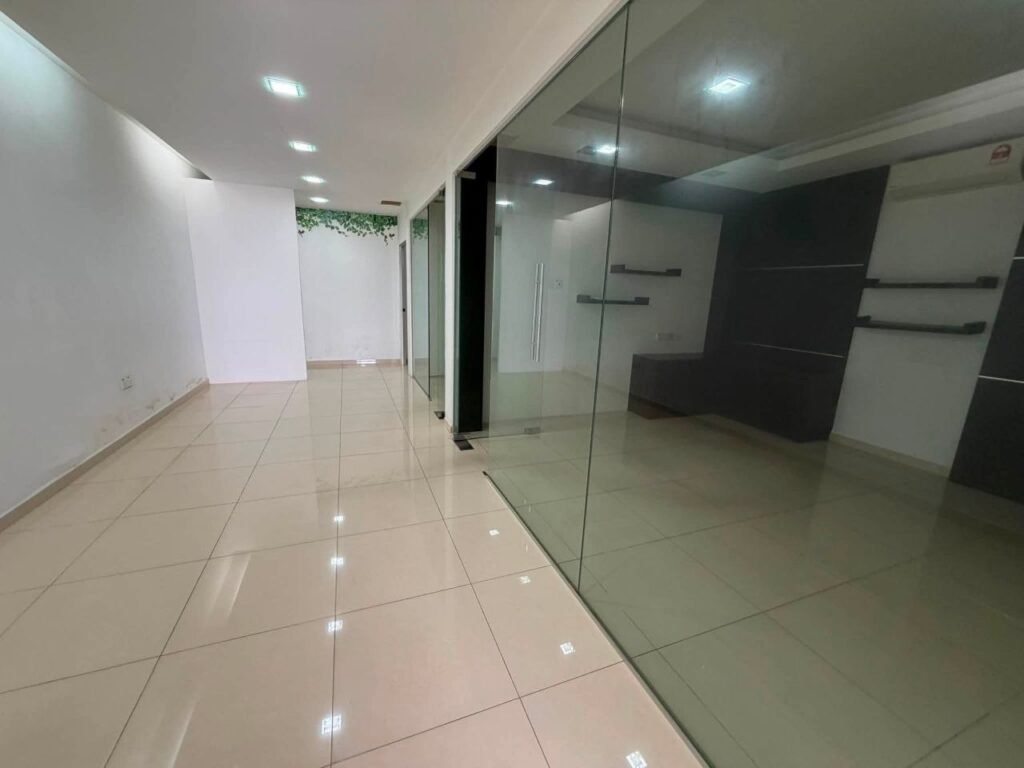 Long hallway beside glass-partitioned rooms