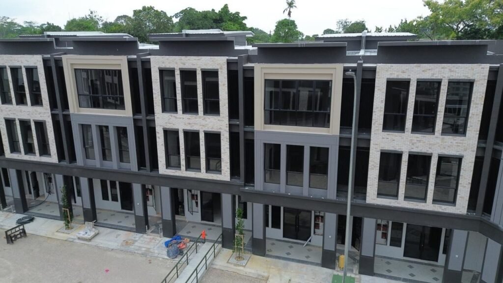 Closer view of the modern shoplot façade with large windows and ground-floor units