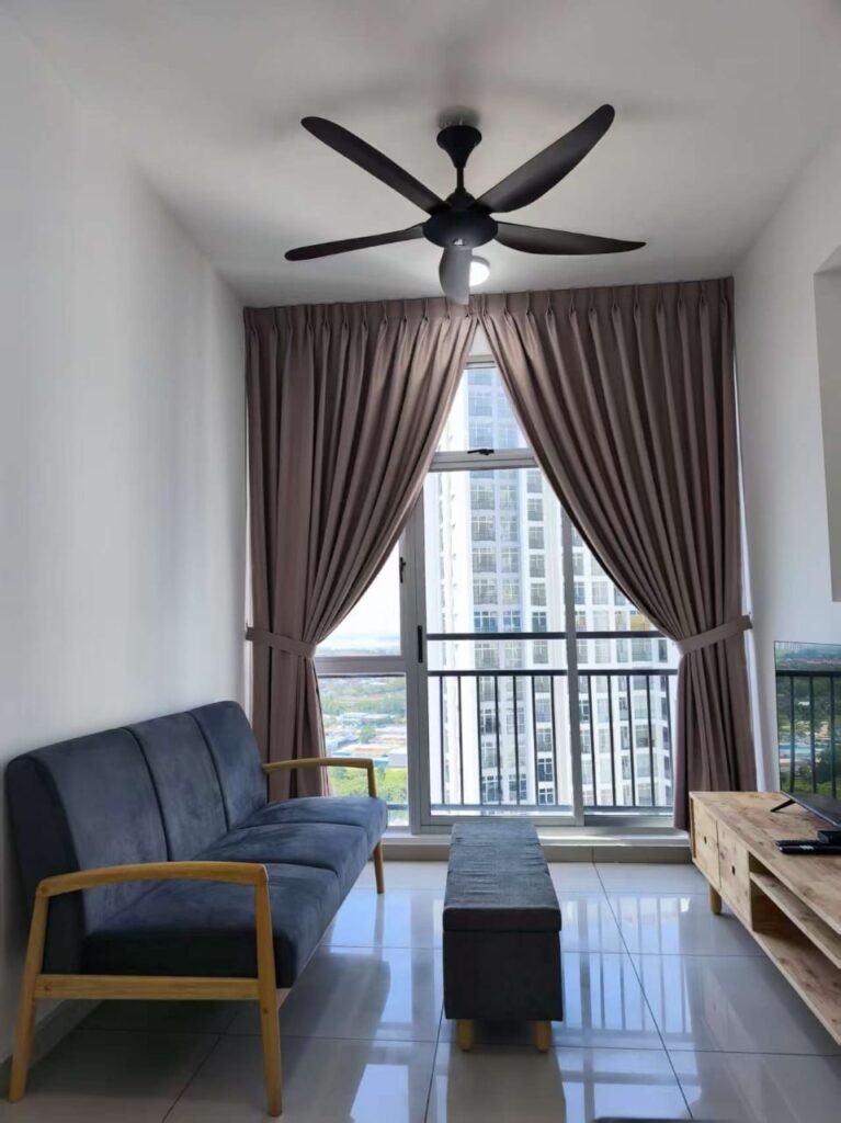 Another angle of the furnished living room showing the sofa, balcony door, and TV console.