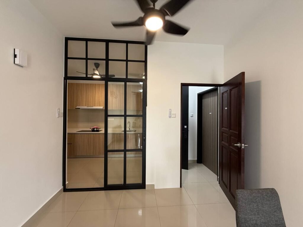 Living area with glass partition facing the kitchen and hallway