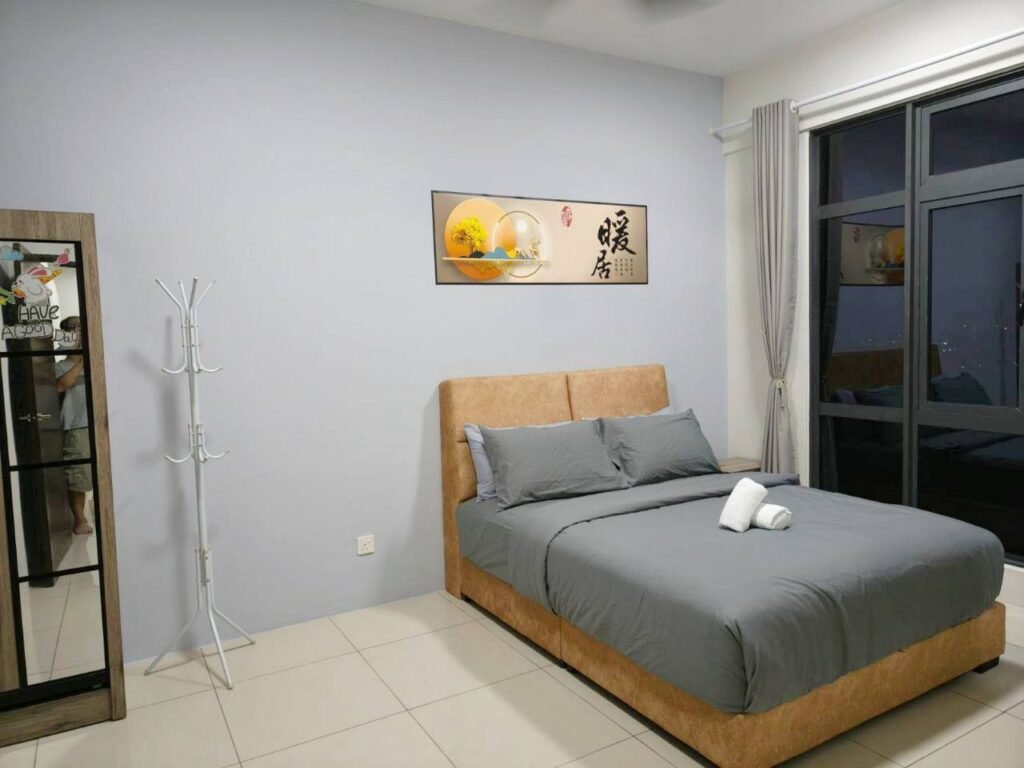 Furnished bedroom with bed, curtains, and window view.