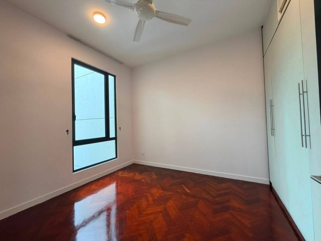 Empty bedroom with ceiling fan, wardrobe and window view