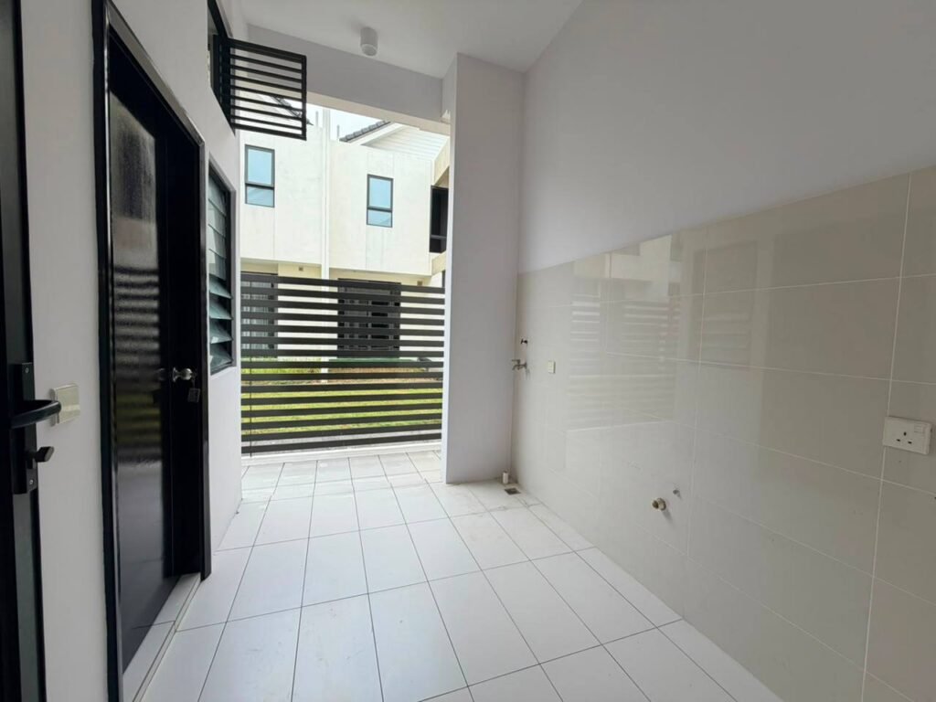 Covered tiled outdoor area beside the house with access to the rear