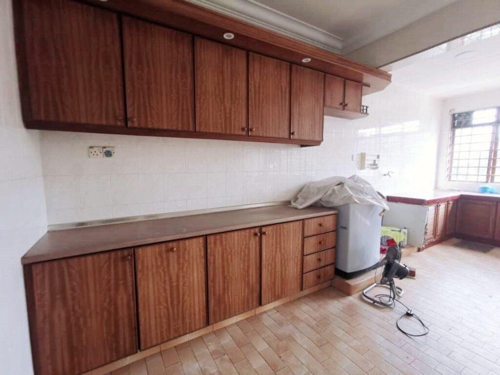 Kitchen with wooden wall cabinets, countertop, tiled backsplash, and utility area.