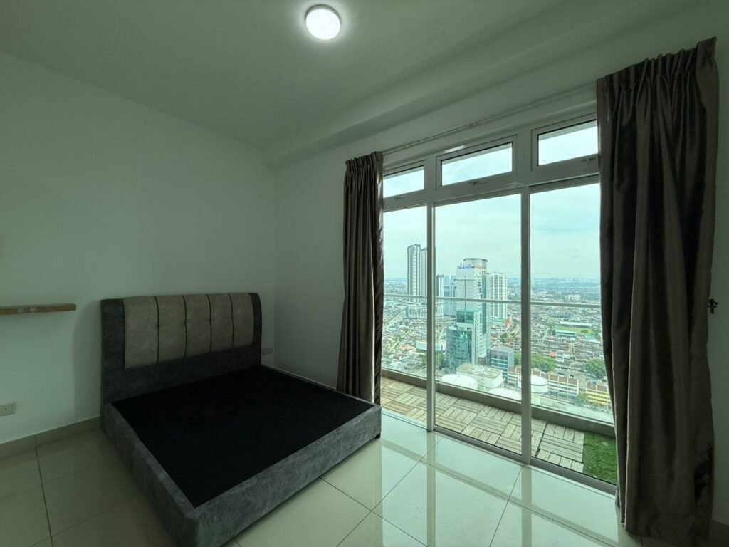 Bedroom with bed frame, curtains, and full-height windows overlooking the city.