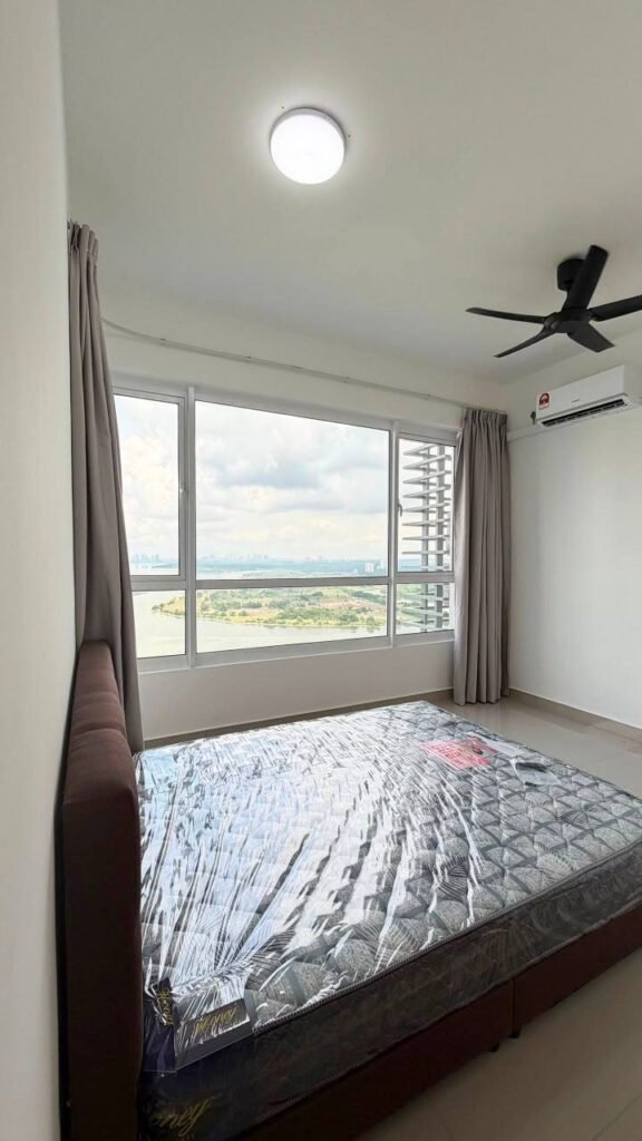 Bedroom with a large window, curtains, bed, and waterfront view.