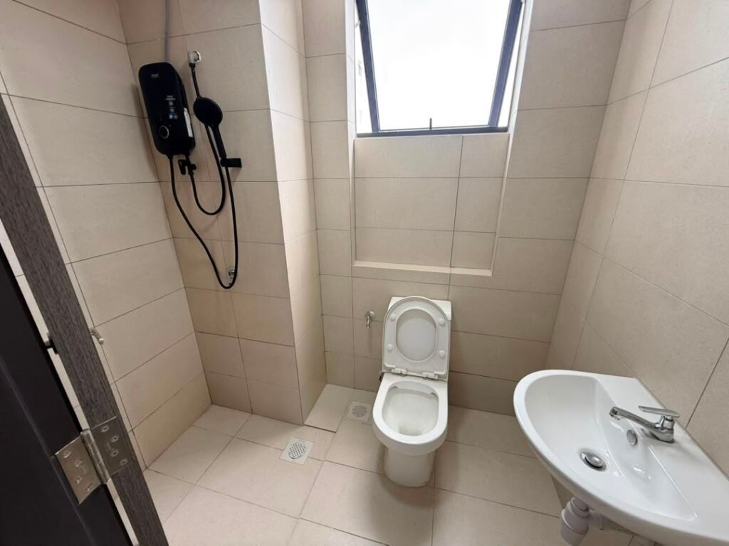 Bathroom with shower heater, toilet, and sink.