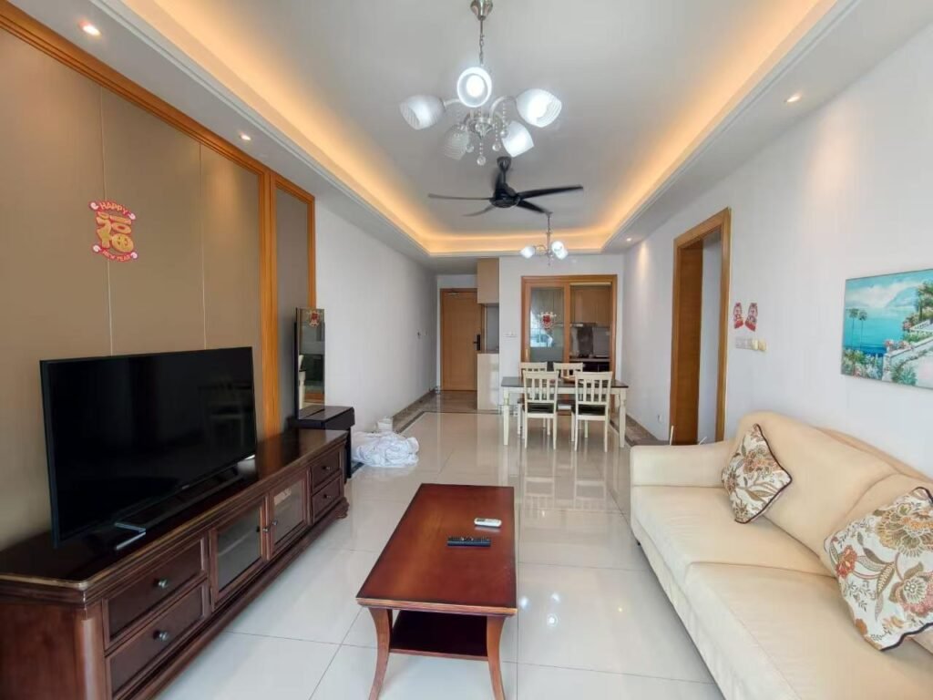 Long living room view with dining table and sofa near the window