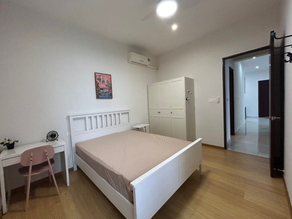 A bedroom with a bed, desk, wall art, and ceiling fan.