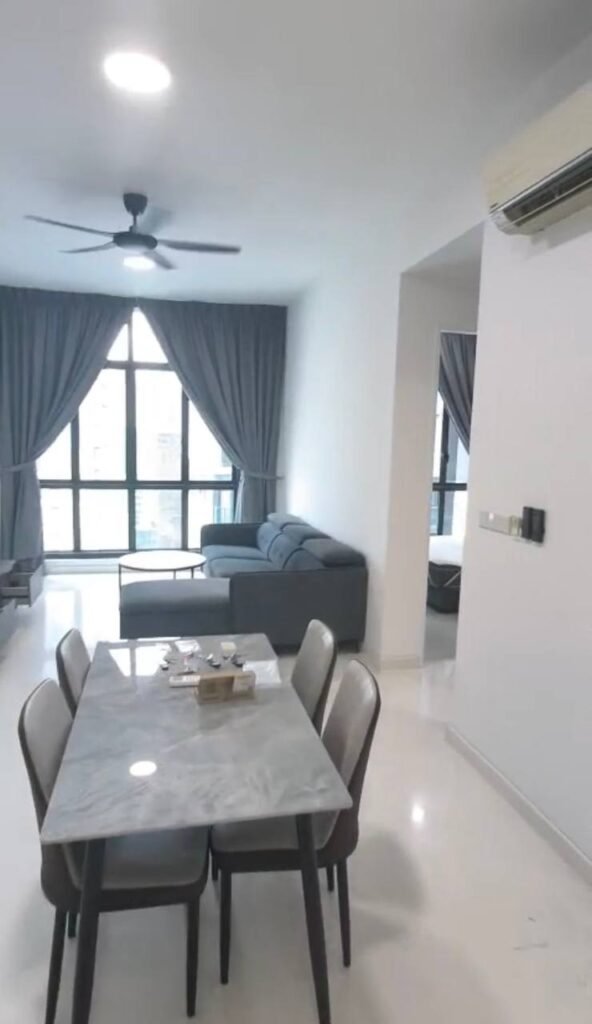 Open-plan living and dining area with sofa, dining table, ceiling fan, and window.