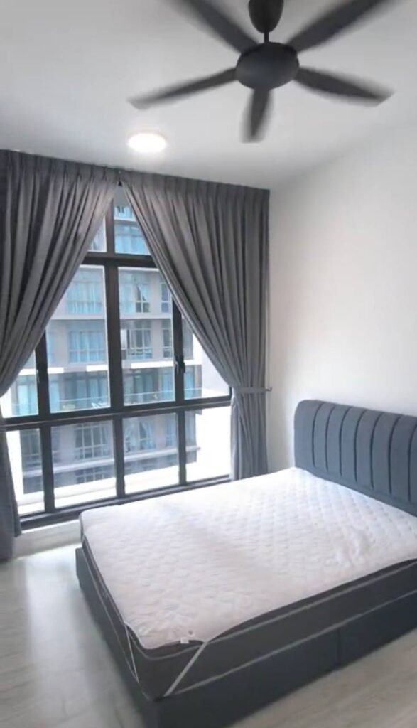 Bedroom with large window, curtains, and bed frame.