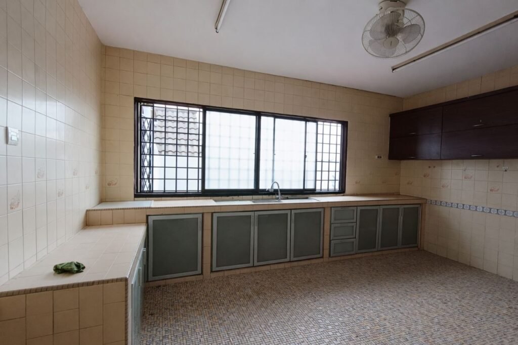 Kitchen with tiled countertops, cabinets, and large window