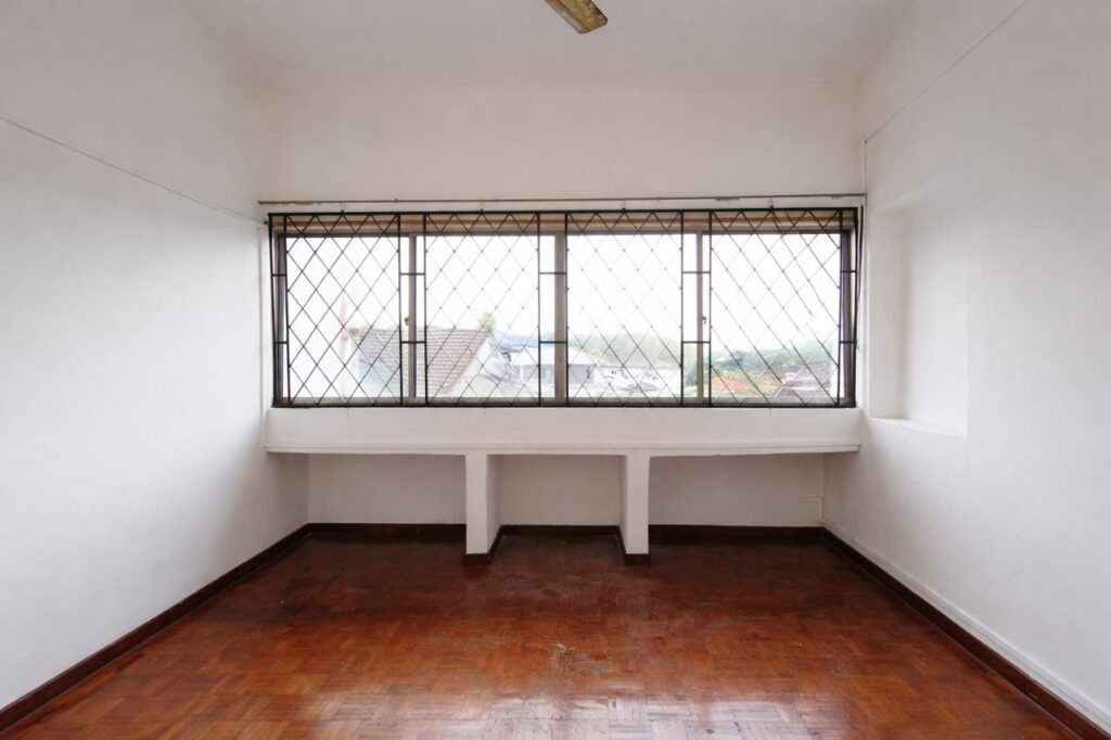 Bedroom with wooden flooring and large grilles window