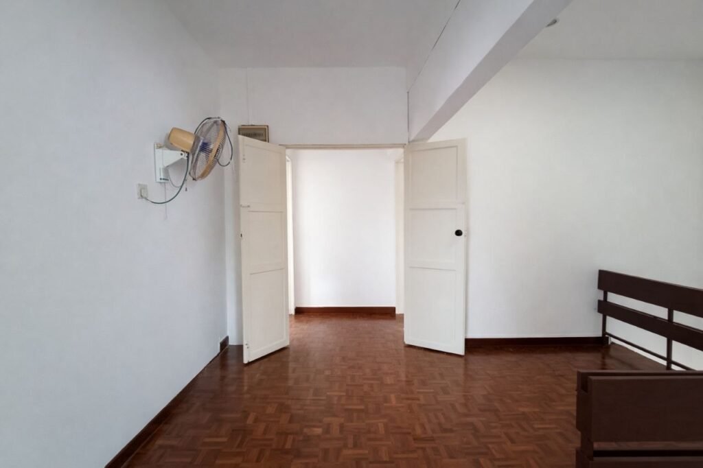 Bedroom with open doors, wooden flooring, and ceiling fan