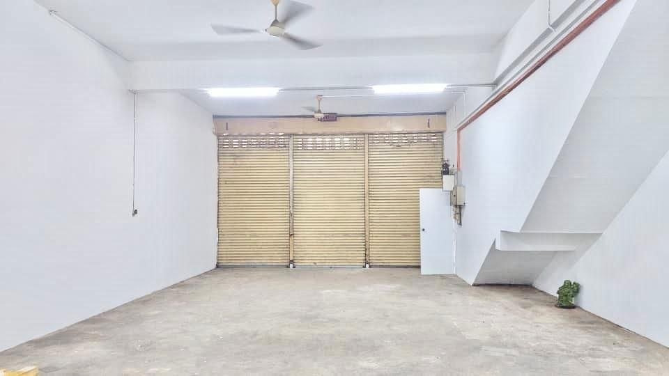 Industrial unit interior with roller shutter frontage and staircase