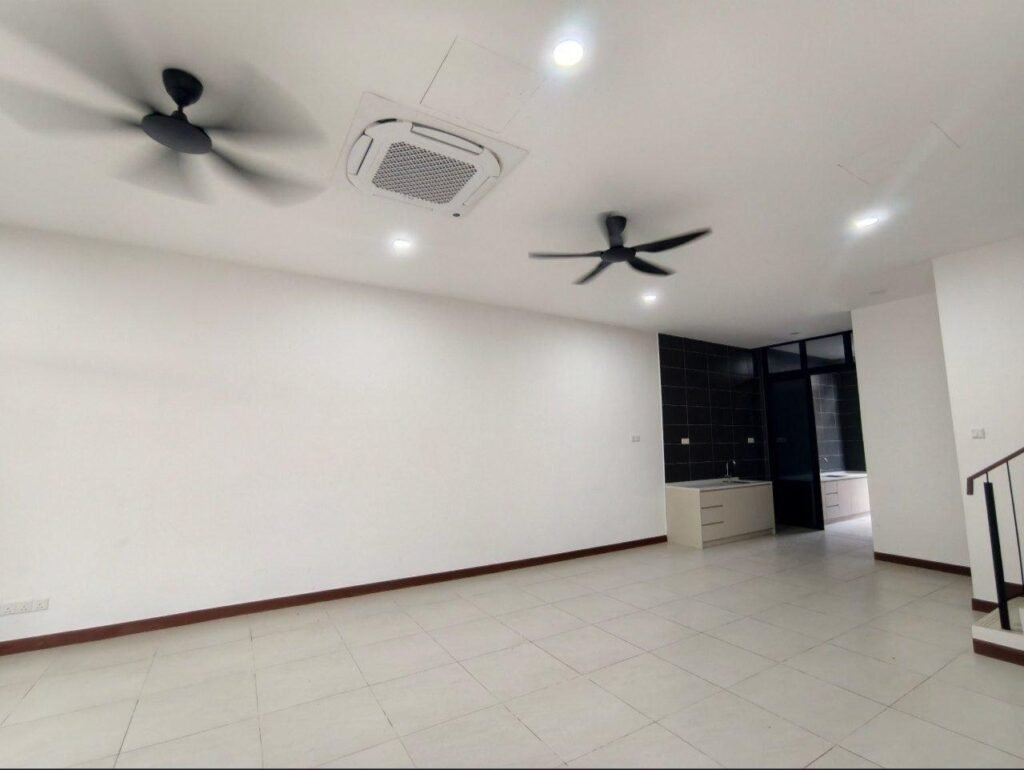 Spacious open living area with ceiling fans and a view toward the kitchen.