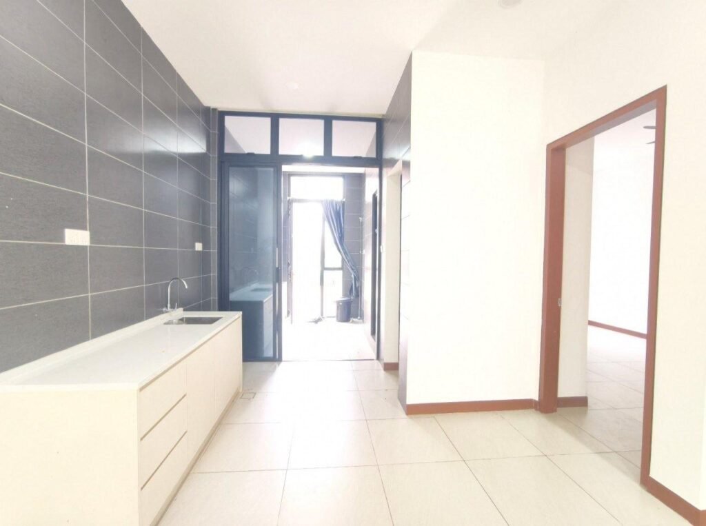 Kitchen area with built-in cabinets, countertop, and tiled walls.