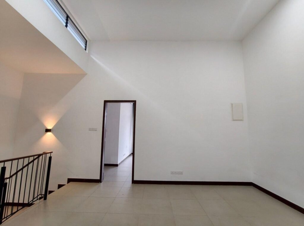 Upper room with high ceiling detail and wall lighting.