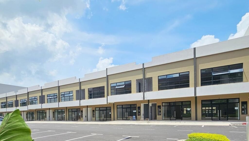 Row of commercial shop units in the development under a bright sky