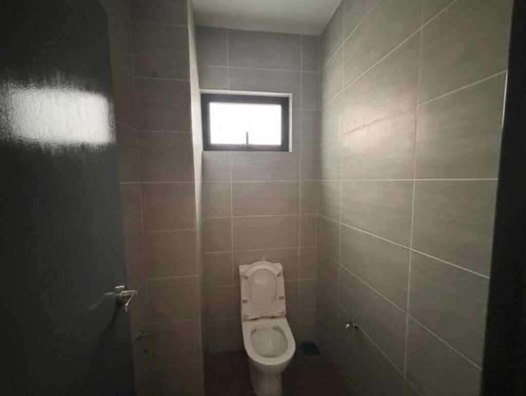 Interior washroom with toilet and wall tiles