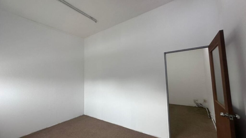 Small empty room with white walls and a doorway