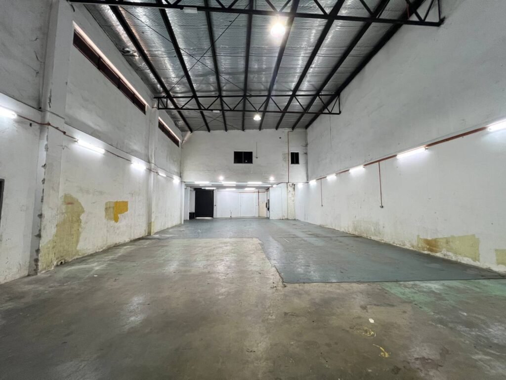 Wide view of the warehouse floor and ceiling structure.