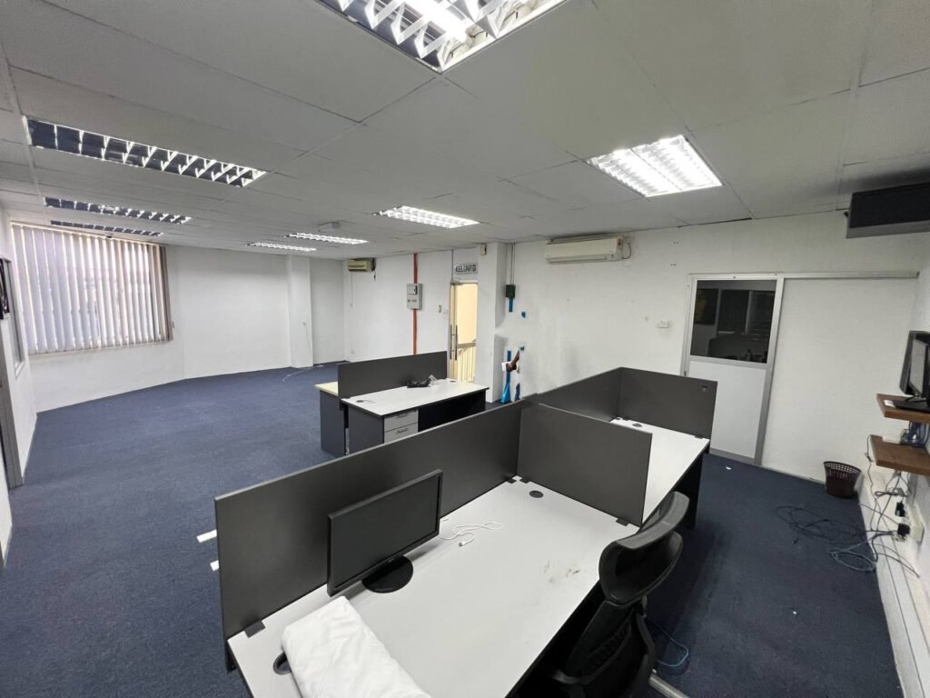Office workspace with desks and partition panels.