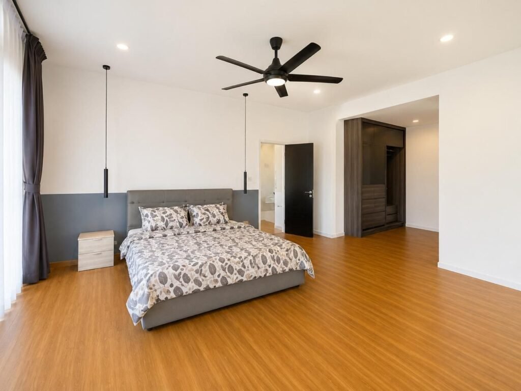 Open interior living space with glossy tiled floor, staircase, and feature wall